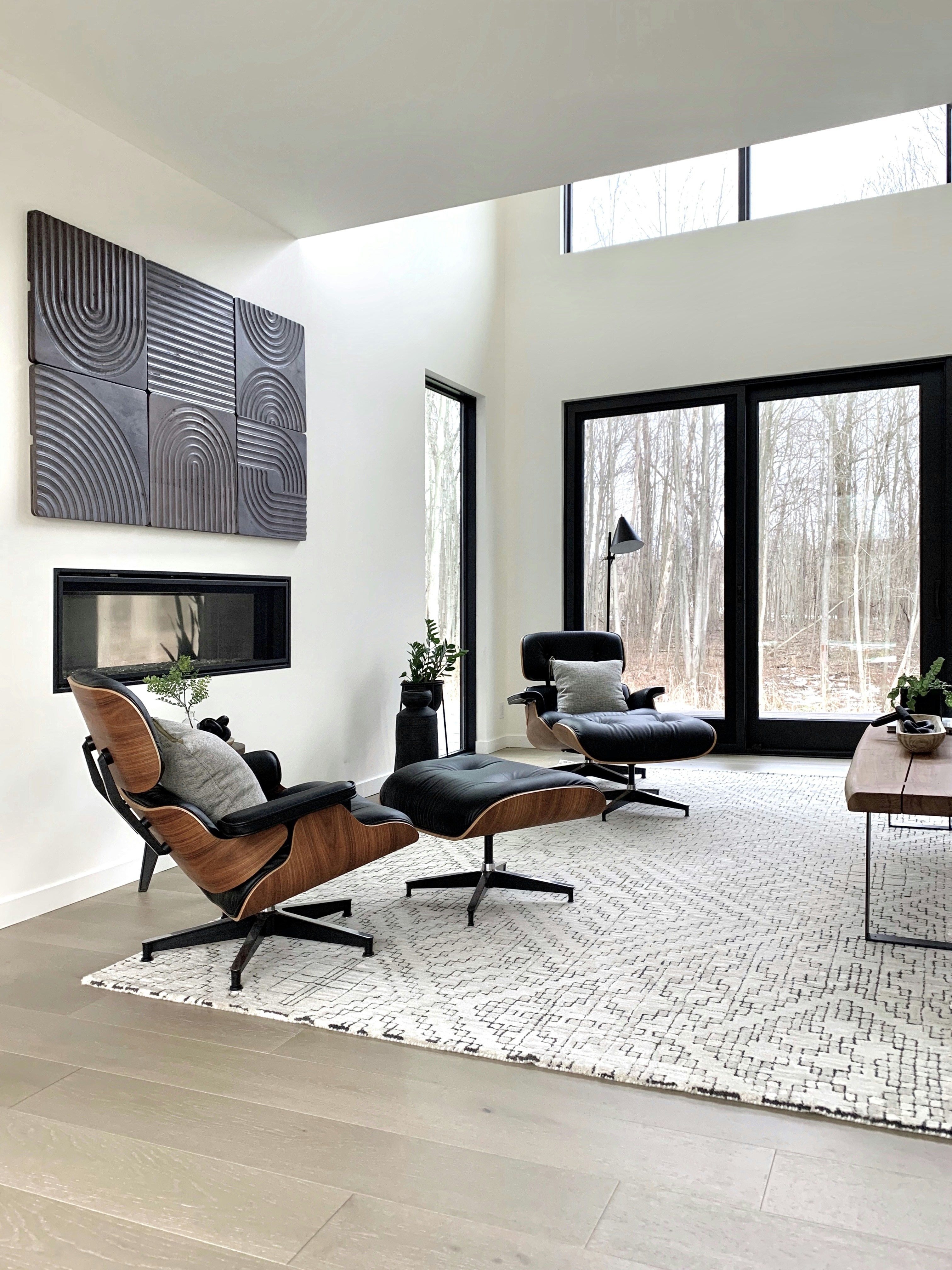 Black leather padded armchair near a black wooden framed glass window
